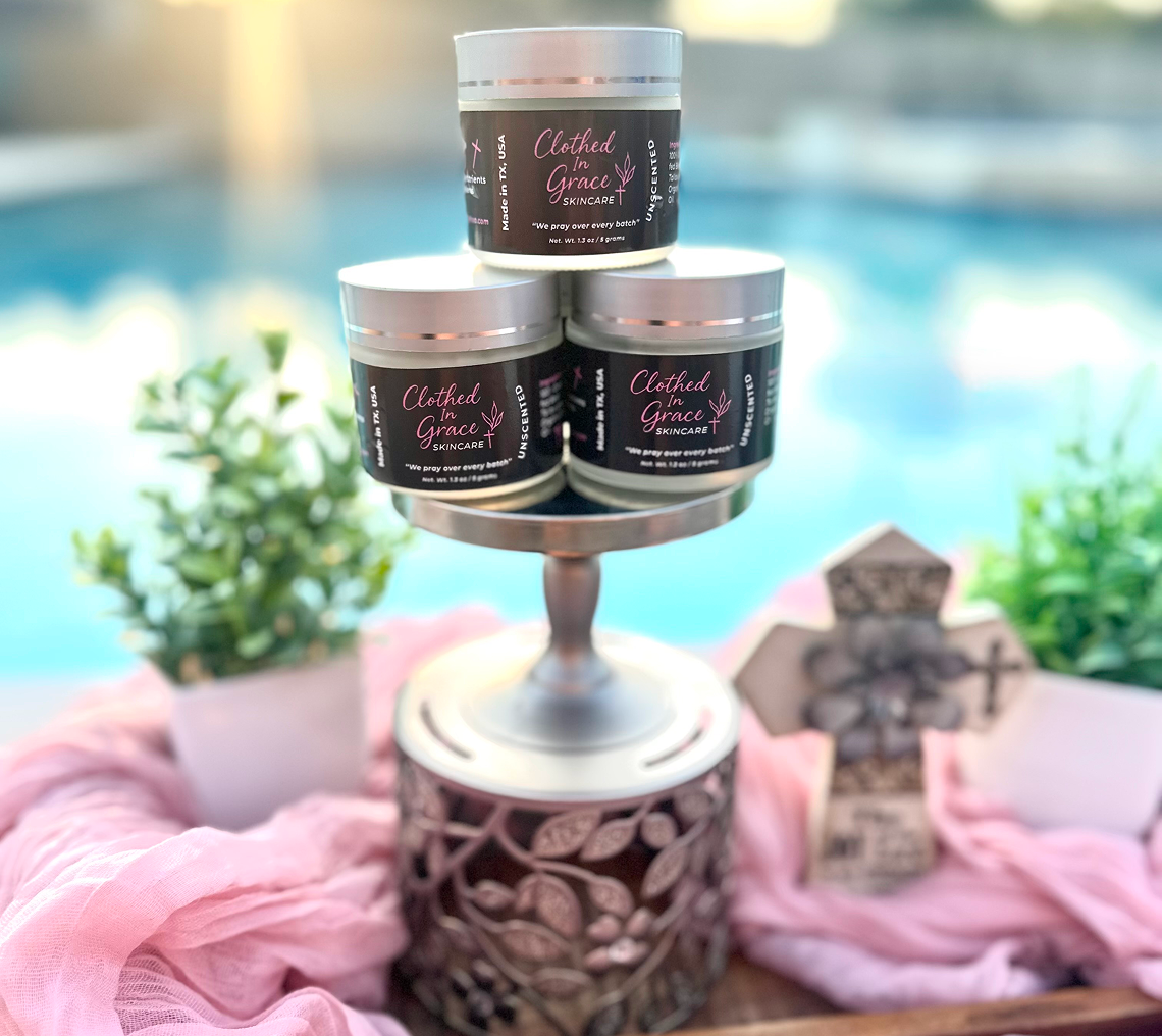 Candles on stand by poolside with plants.